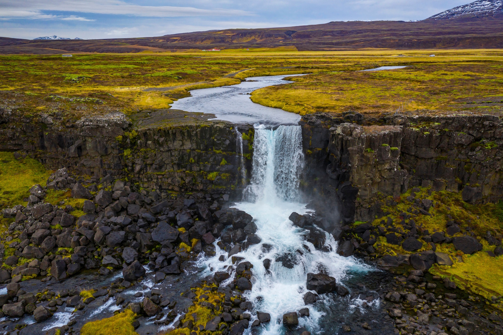 Small waterfall in the Thingvellir National Park under a cloudy sky in Iceland